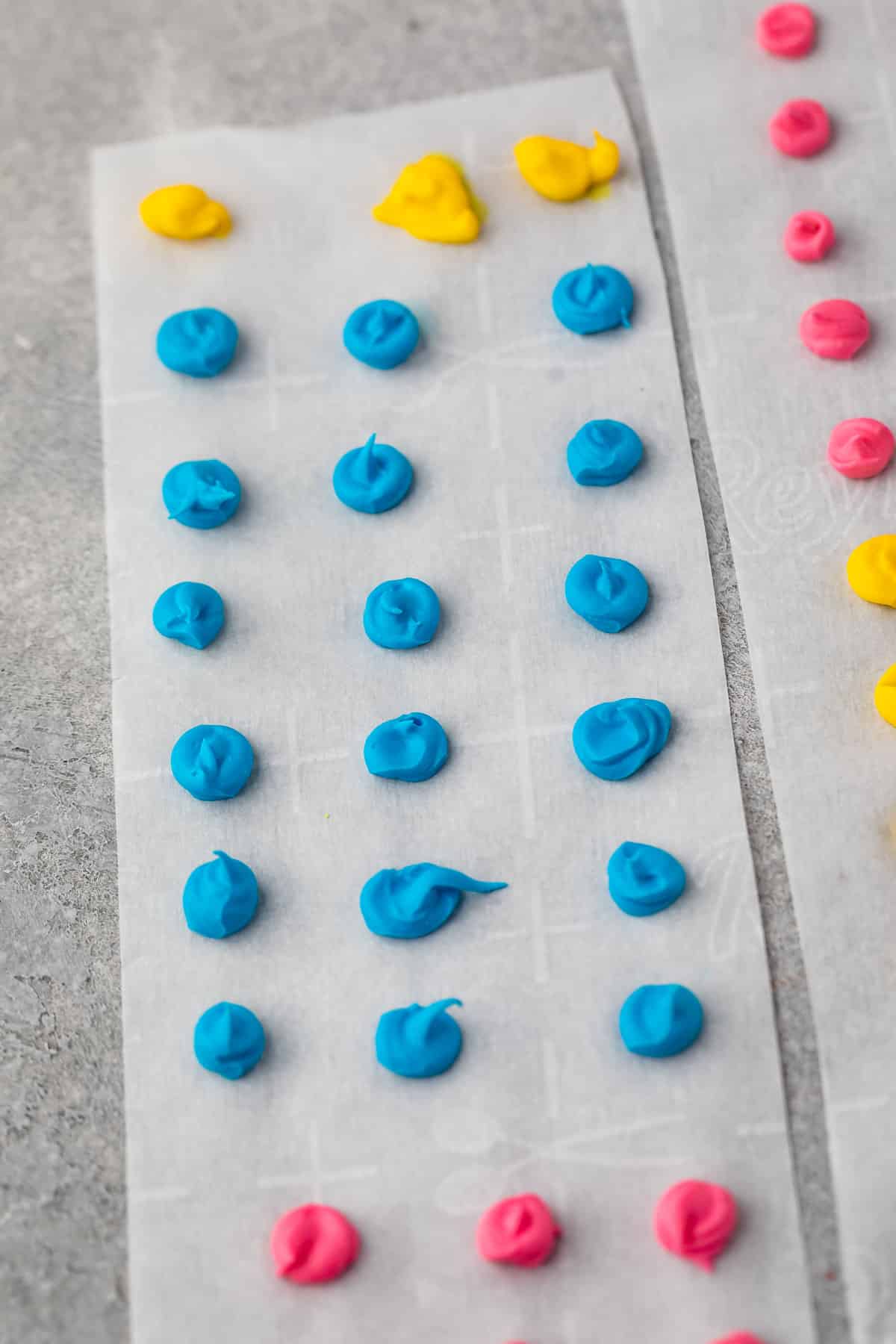 blue, pink and yellow buttons on parchment paper