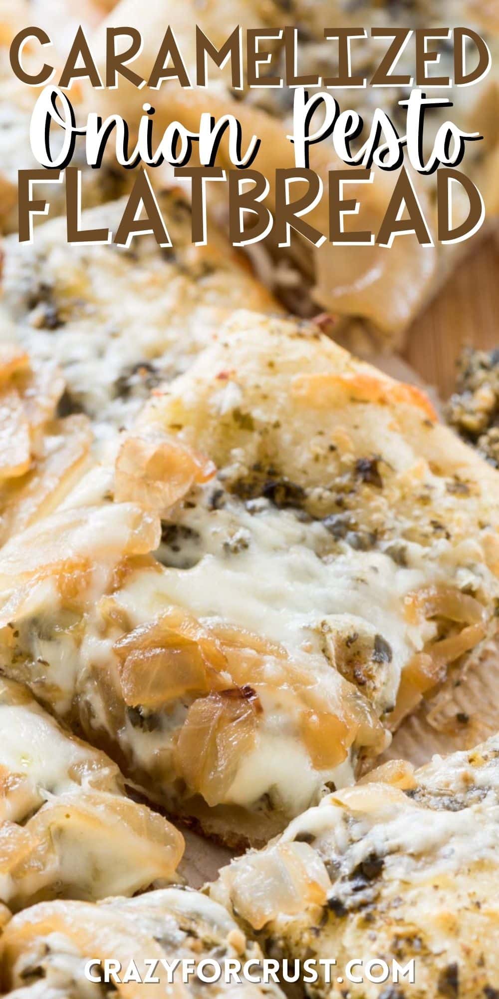 flatbread with onions and pesto on top laid out on a cutting board with words on top