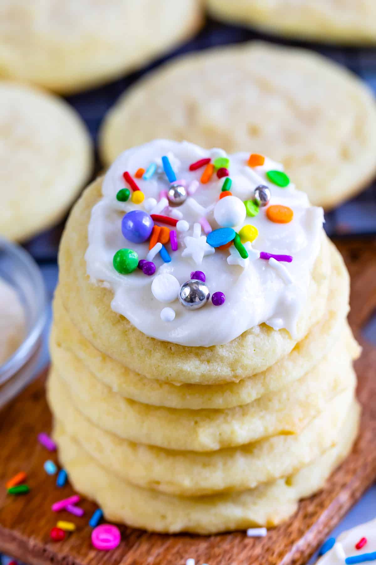 stacked sugar cookies with white icing and sprinkles on top