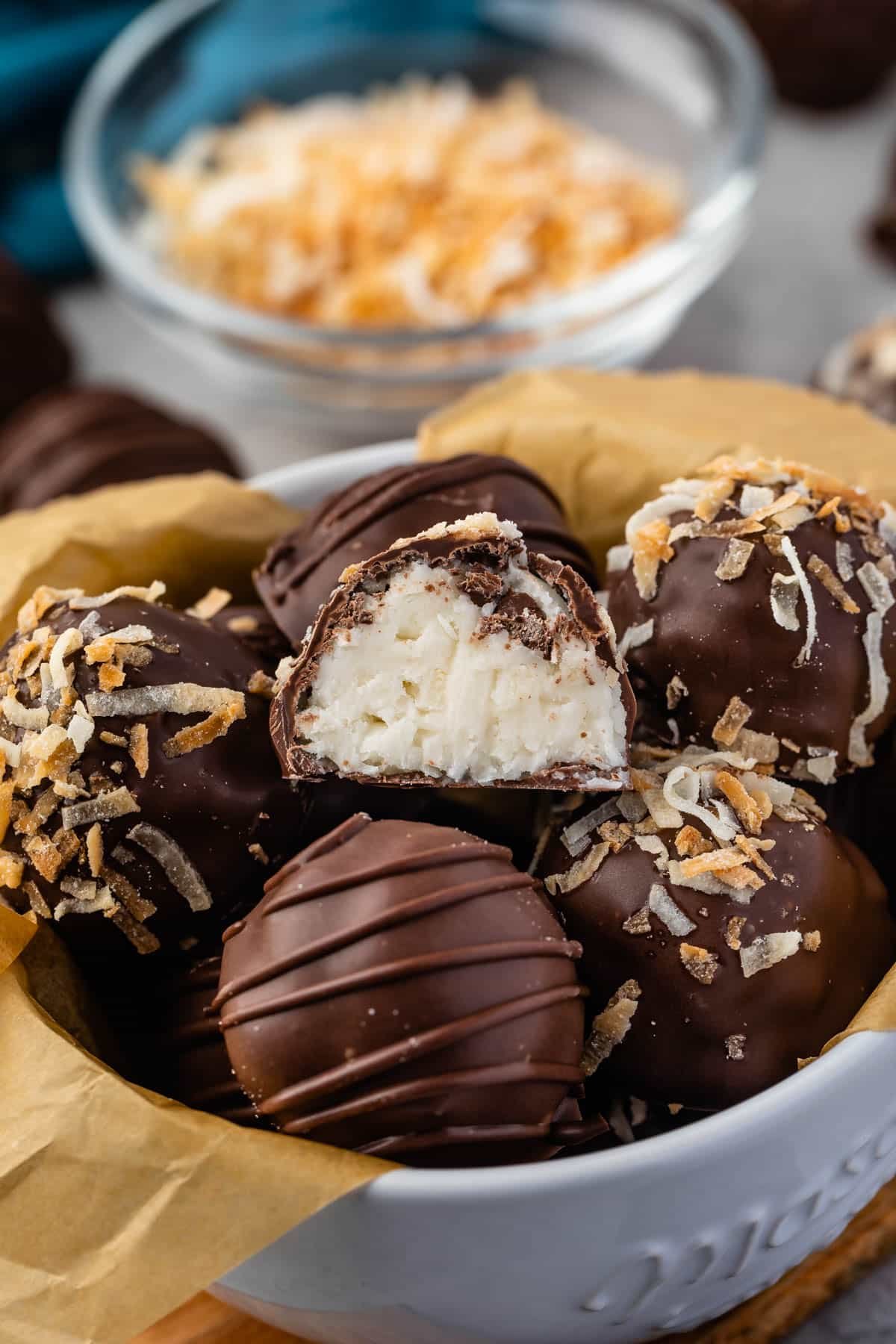 Coconut Cream Truffles | www.crazyforcrust.com | Triple the coconut flavor! truffles covered in chocolate in a white bowl
