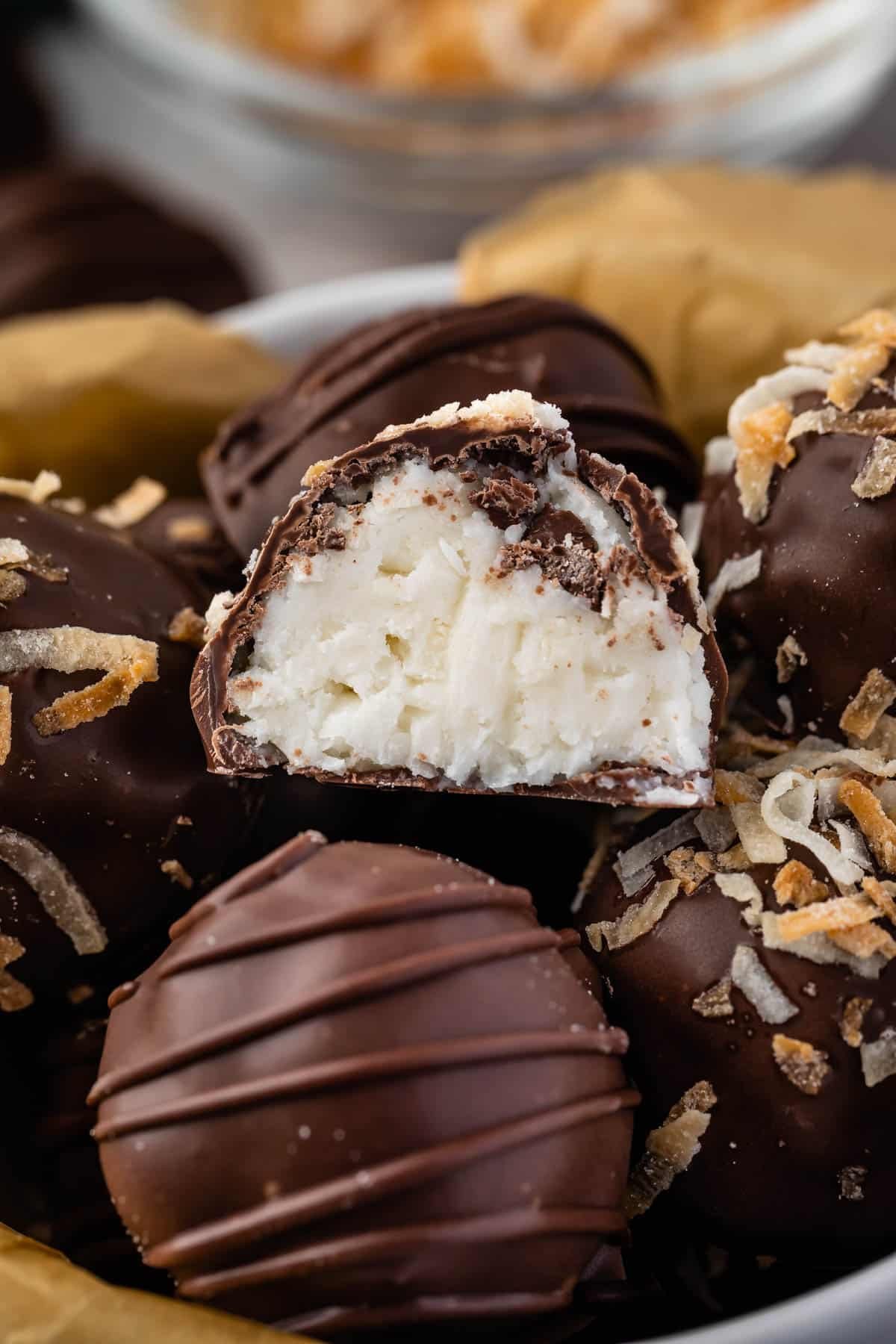 truffles covered in chocolate in a white bowl.