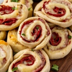 multiple pinwheels laid out on a dark cutting board