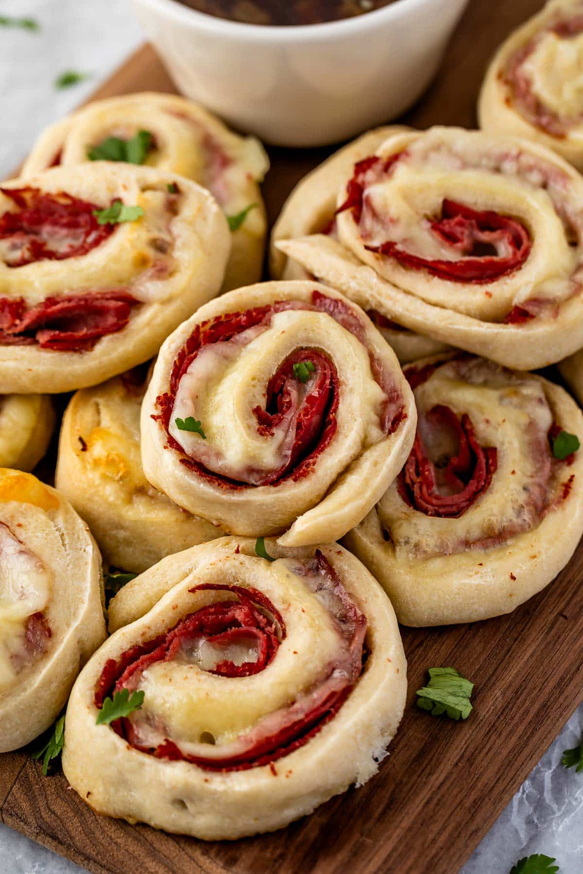 multiple pinwheels laid out on a dark cutting board