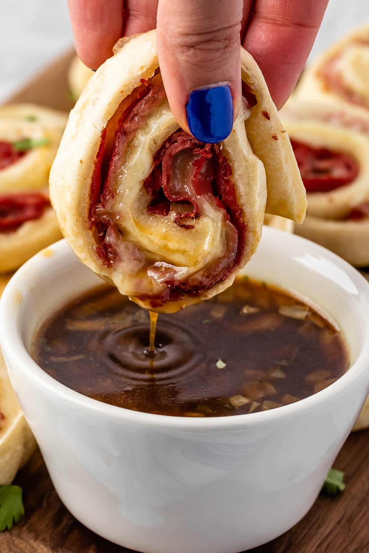 pinwheels being dipped in sauce