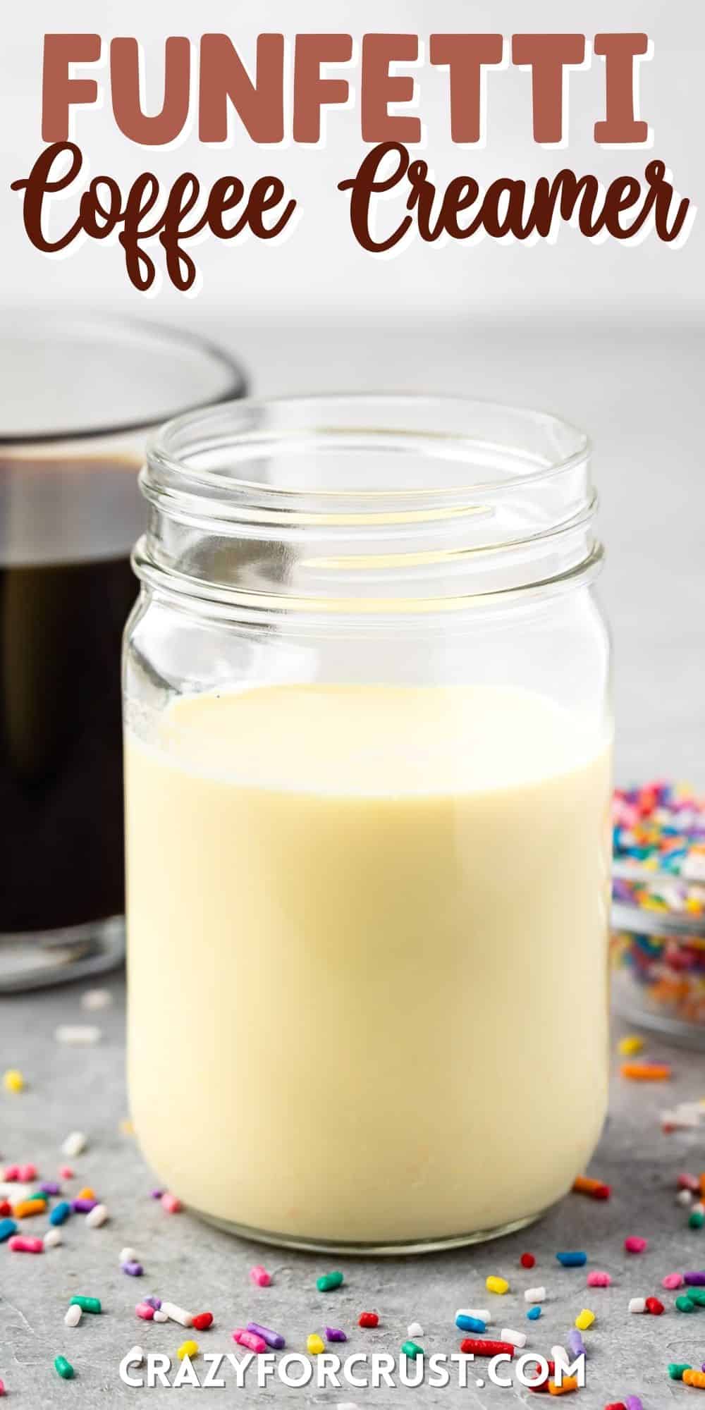 mason jar with creamer inside and sprinkles around the glass with words on top