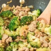 broccoli and meat mixed together in a black pan with words on the image