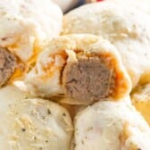 stacked buns with a meatball in the center on a white plate