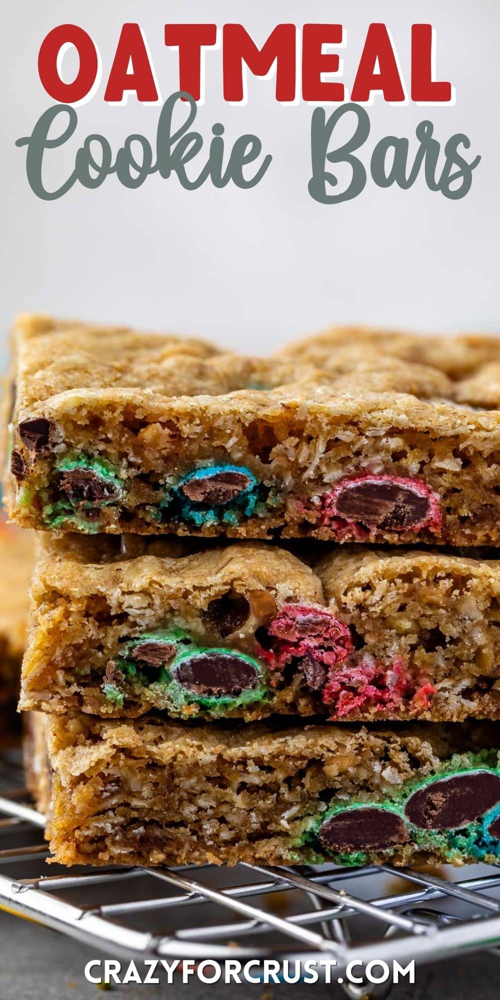 stacked oatmeal bars with m&ms baked in with words on the image