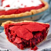 red velvet pie on a grey plate next to a fork