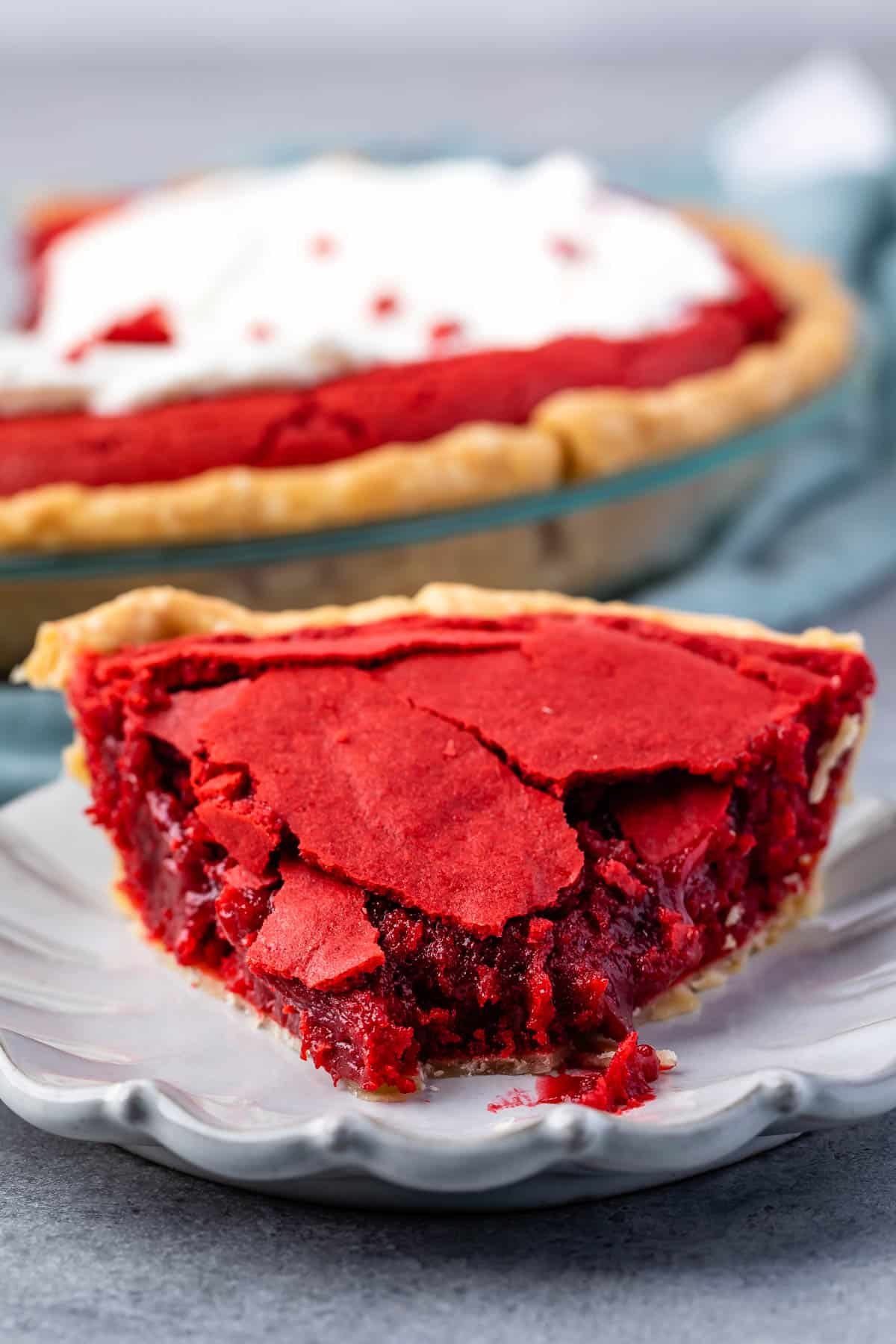 red velvet pie on a grey plate next to a fork