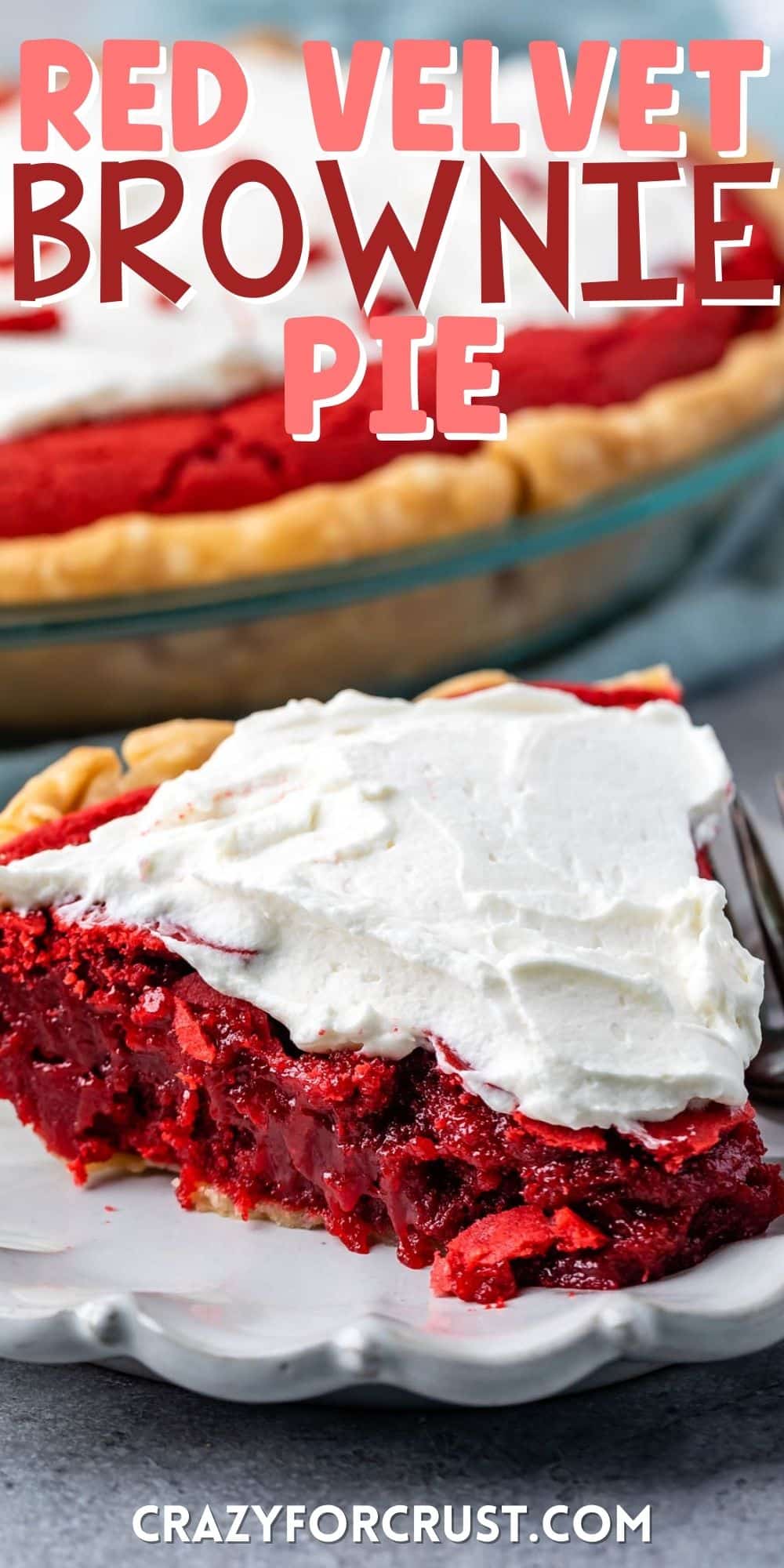 one slice of red velvet pie with white frosting on top on a grey plate with words on top