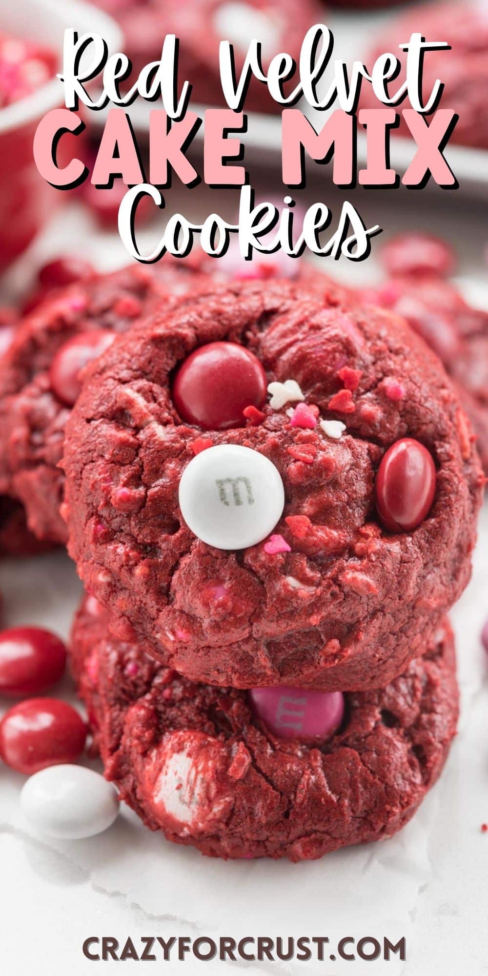 red cookies with red and white m&ms baked in and words on the image