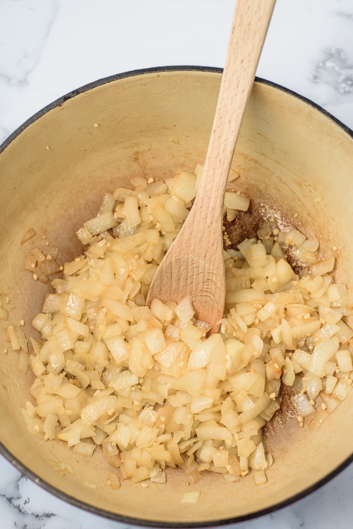 onions sauteeing in pot with spoon