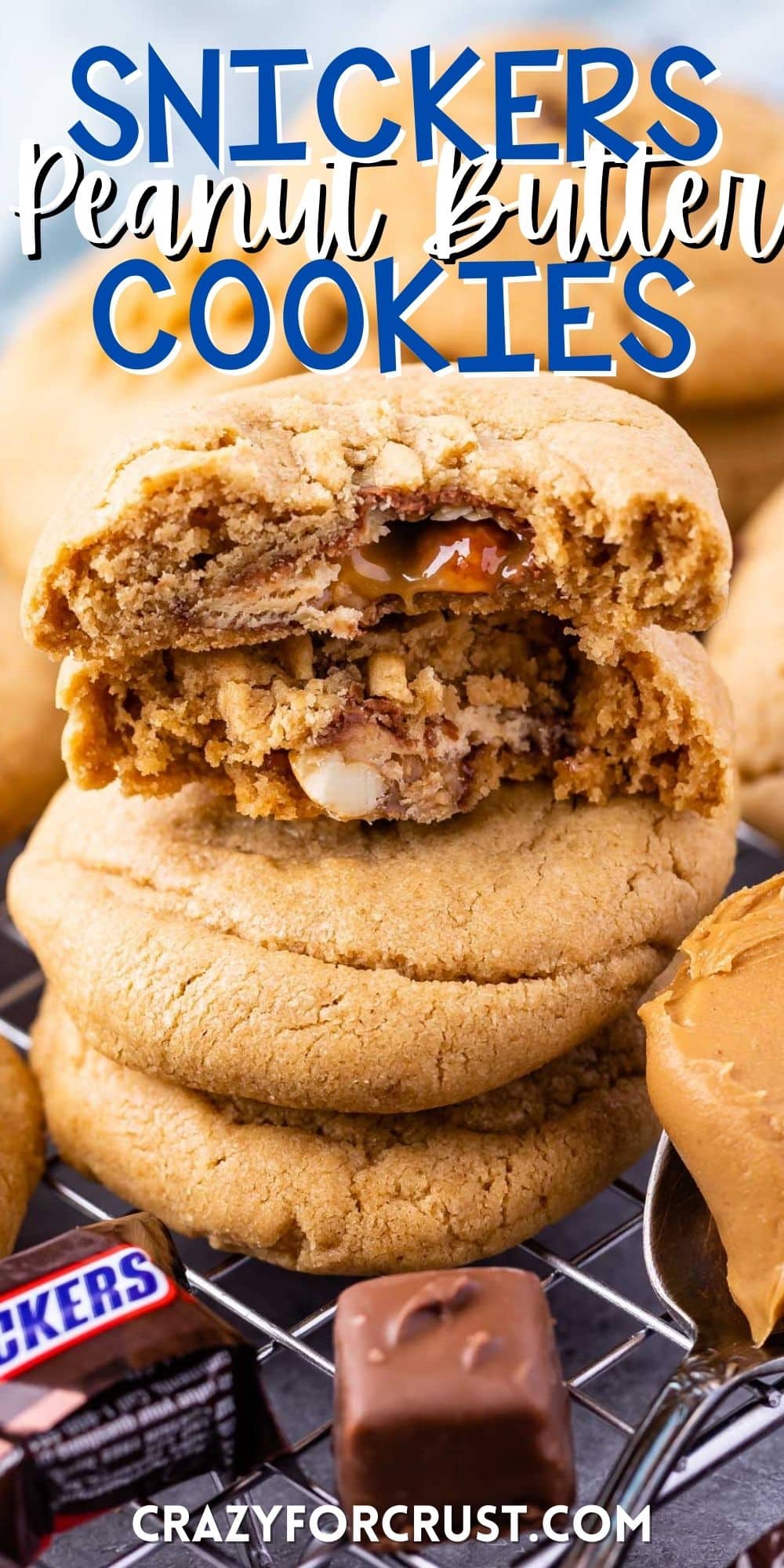 stacked peanut butter cookies with a snickers baked inside with words on the photo.