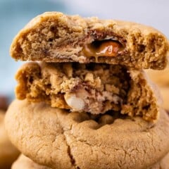 stacked peanut butter cookies with a snickers baked inside.