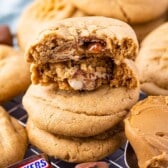 stacked peanut butter cookies with a snickers baked inside.