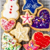 sugar cookies with various colored icing and sprinkles on top