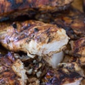 chicken pulled on a wooden cutting board.