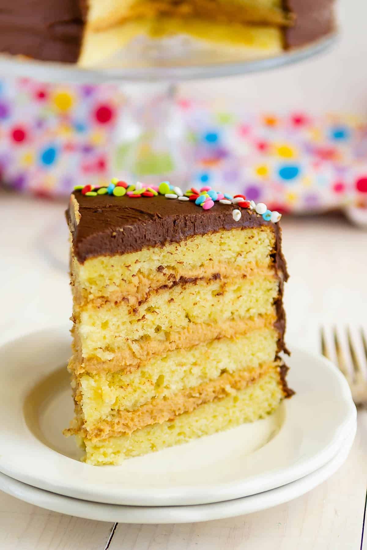 one slice of yellow cake with peanut butter frosting.