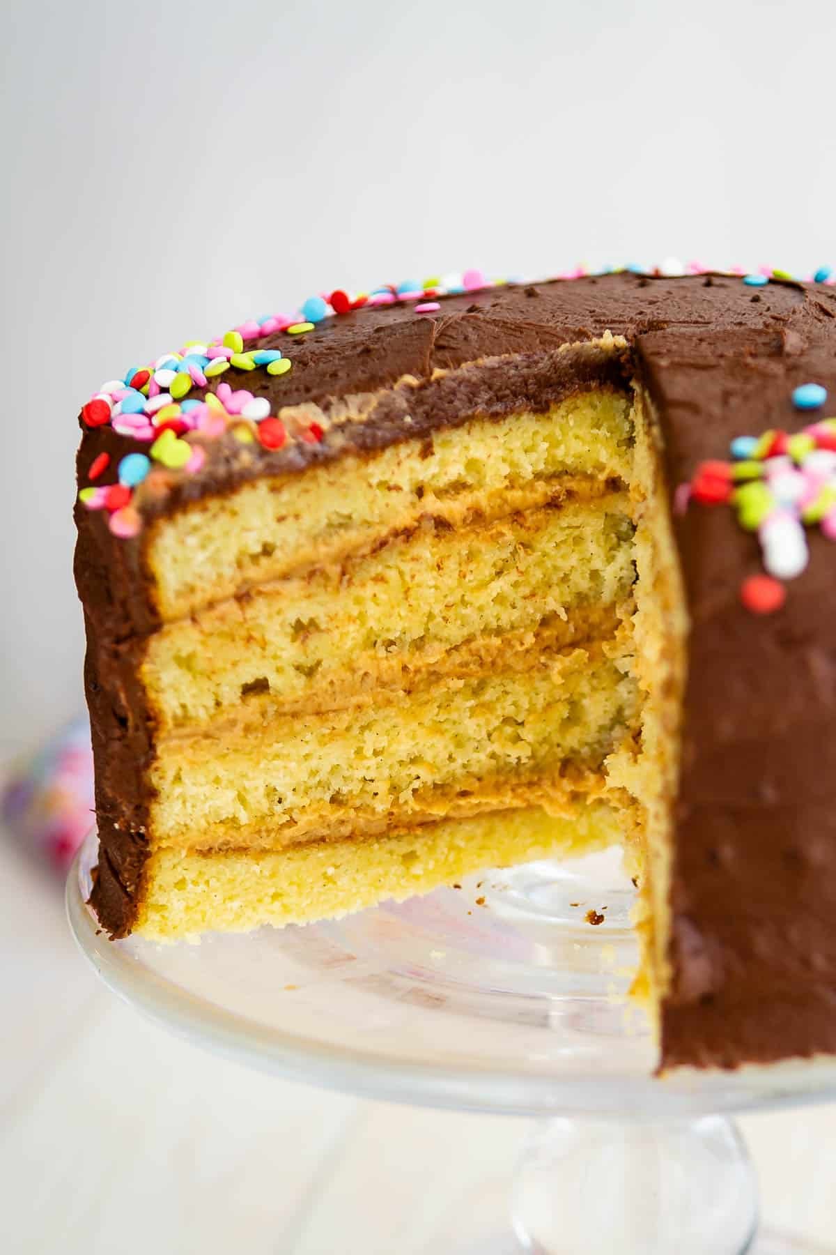 one slice of yellow cake with peanut butter frosting.