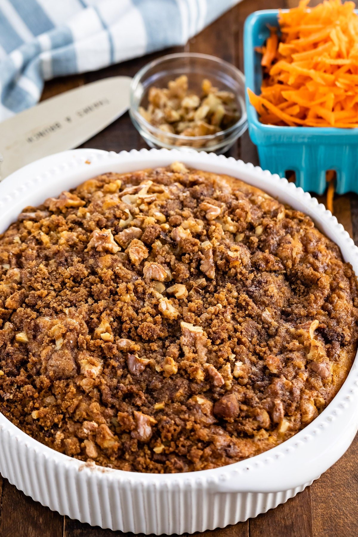 coffee cake with carrots baked in on a white plate.