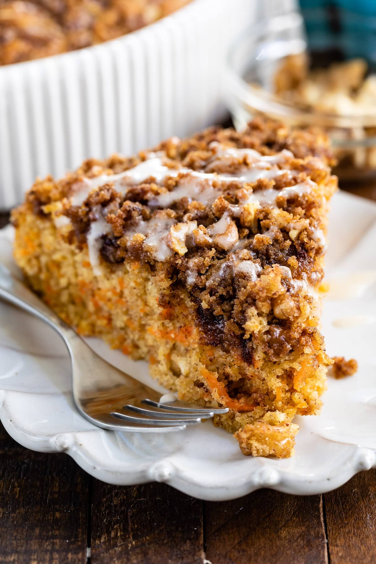 one slice of coffee cake with carrots baked in on a white plate.