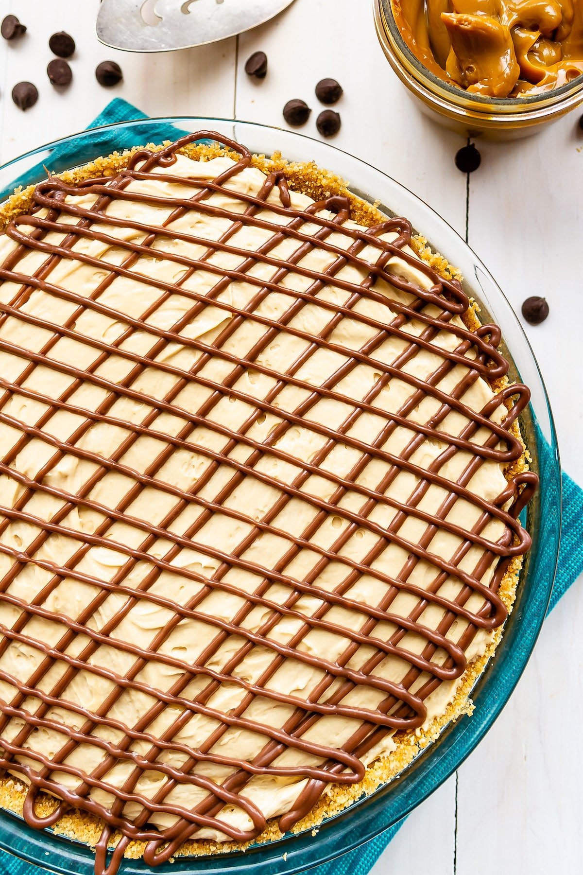 pie in a clear pan covered in chocolate frosting.