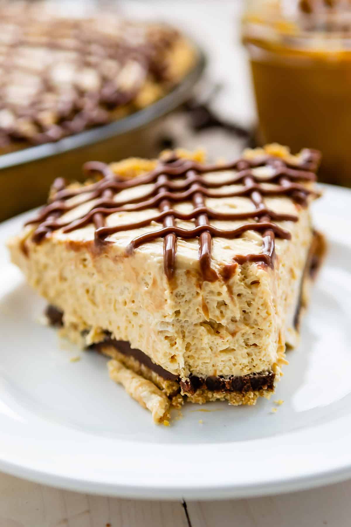 pie on a white plate covered in chocolate frosting.