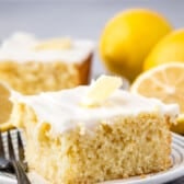 lemon cake with white frosting and a lemon slice on top.