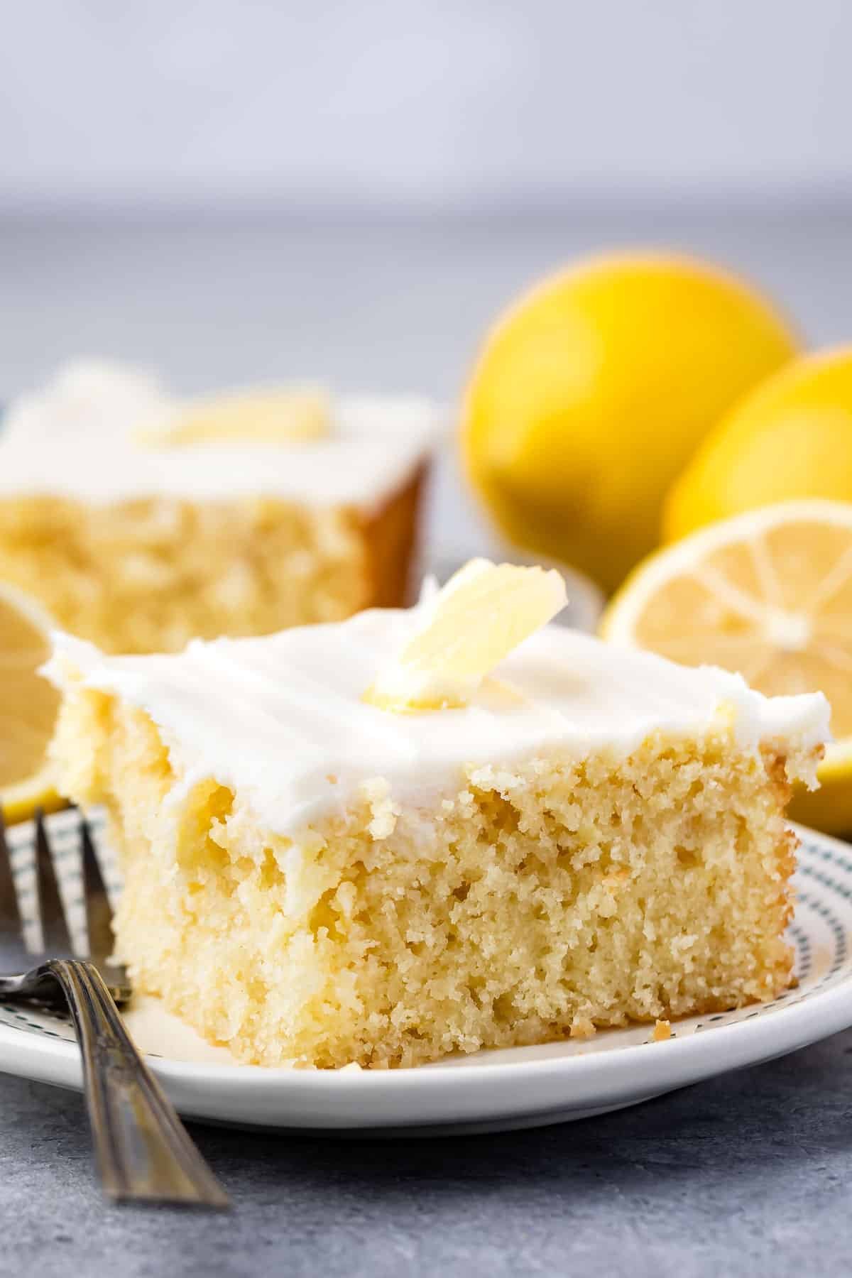 lemon cake with white frosting and a lemon slice on top.
