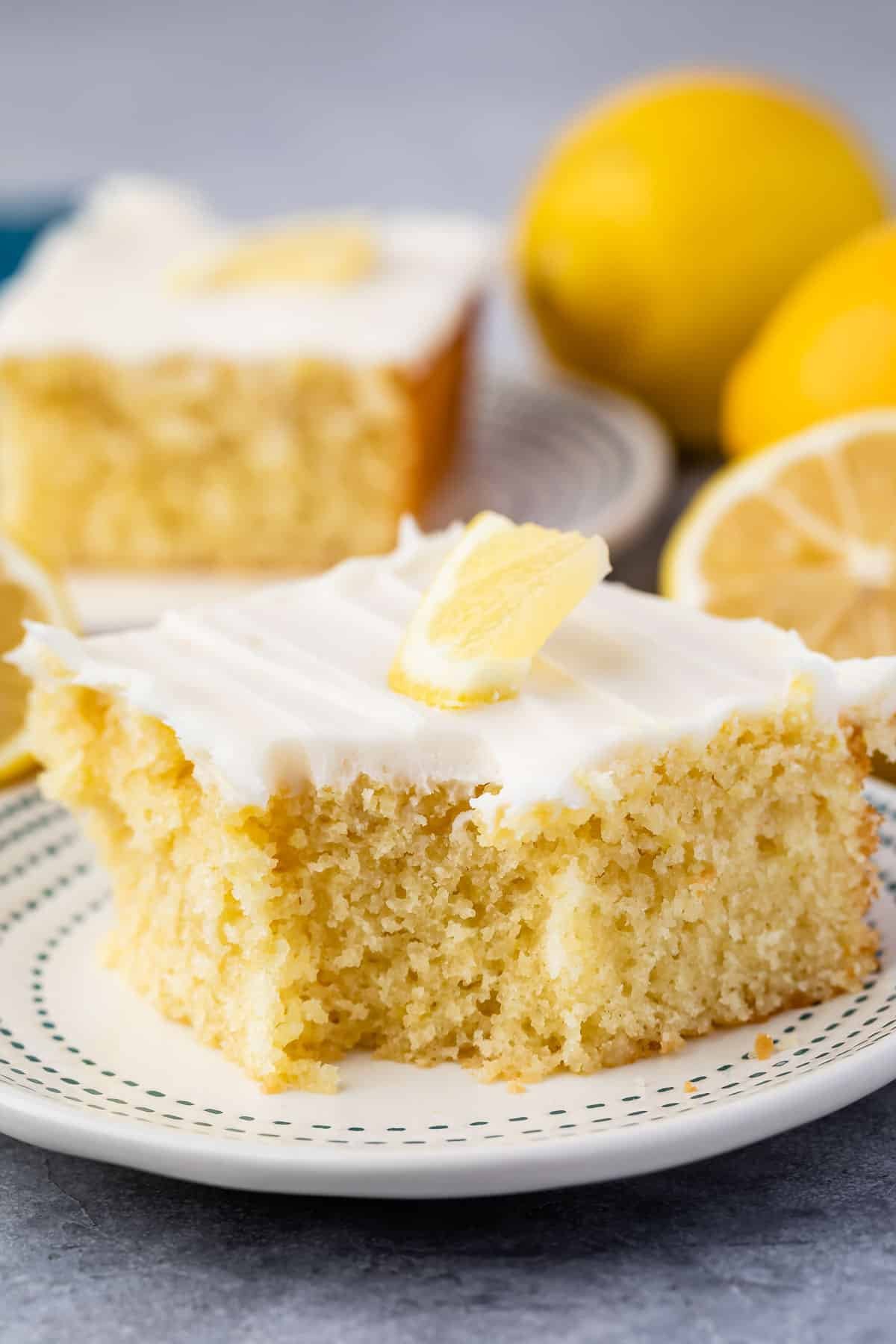 lemon cake with white frosting and a lemon slice on top.