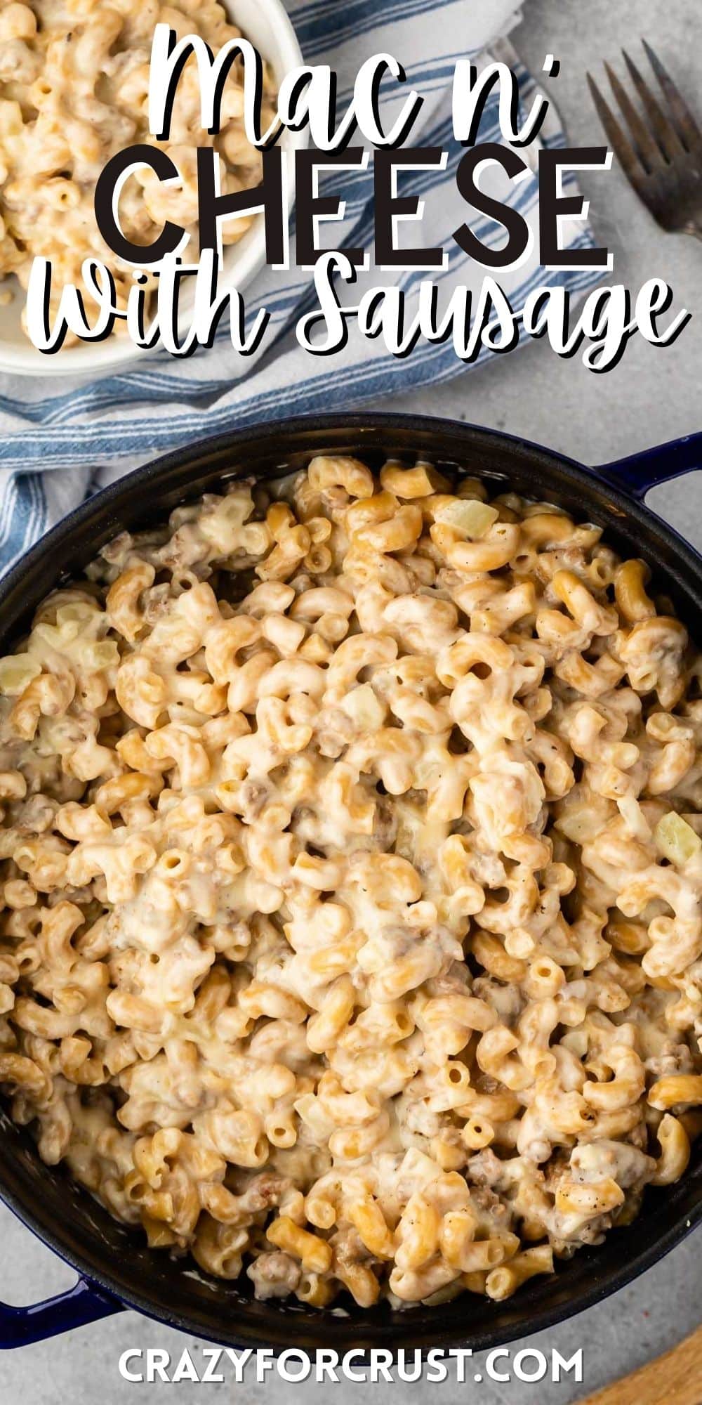 Mac and cheese in a black pan with words on the image.