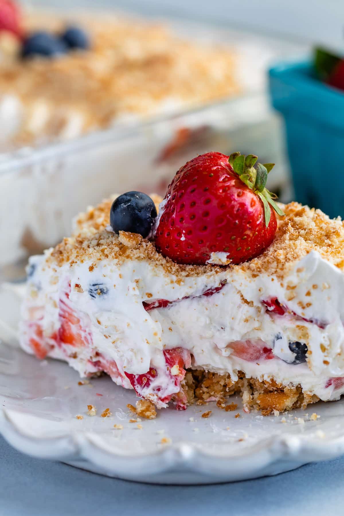 berry lush dessert topped with blueberries and bread crumbs.