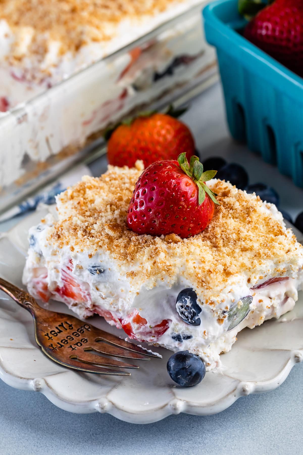 berry lush dessert topped with blueberries and bread crumbs.