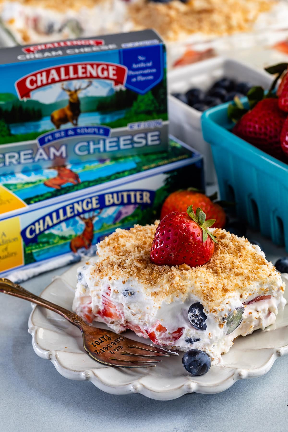 berry lush dessert topped with blueberries and bread crumbs.