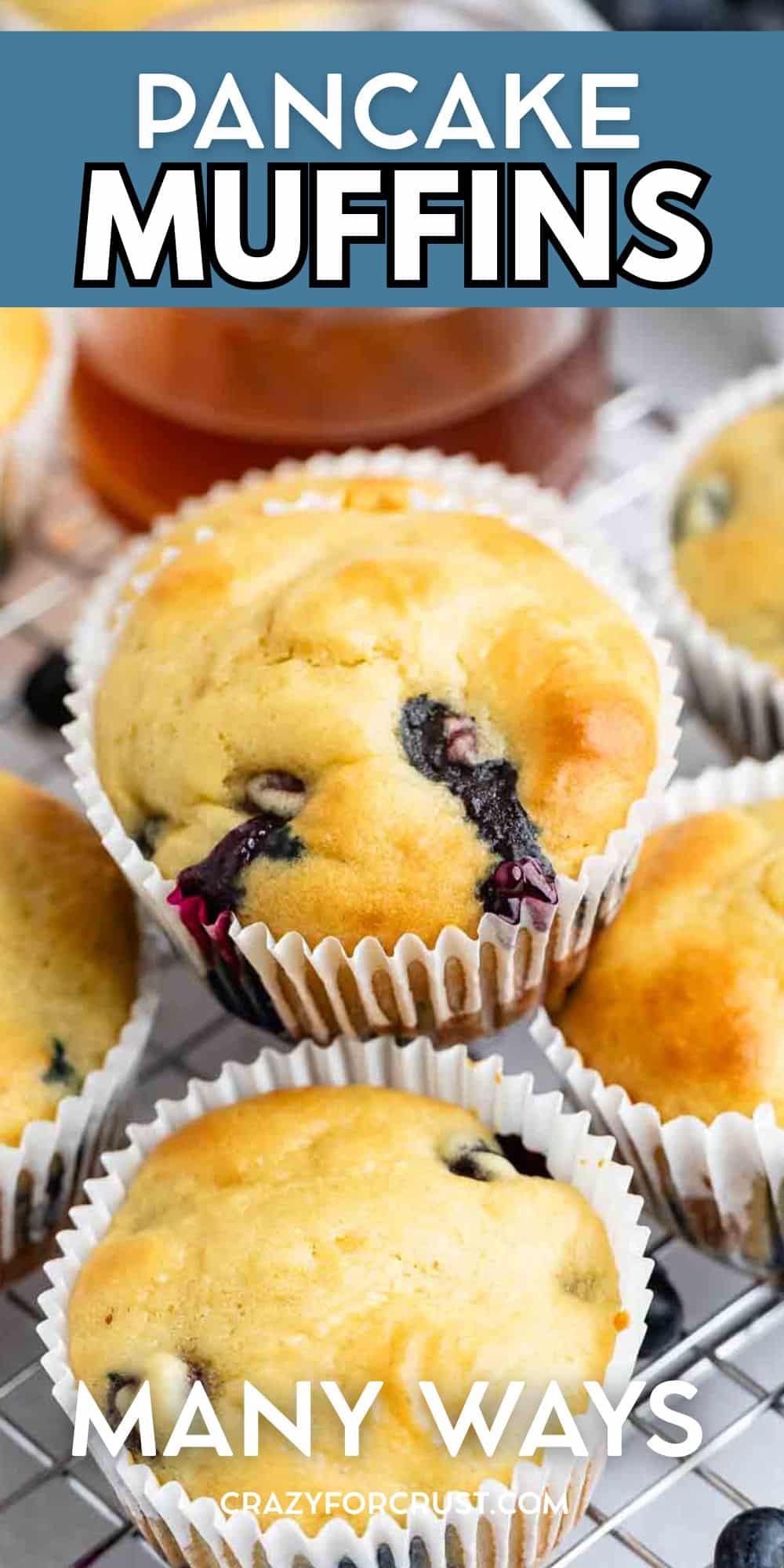 Three baked Pancake Muffins, some with juicy blueberries, are arranged in white paper liners on a cooling rack. The text over the image reads Pancake Muffins and Many Ways.