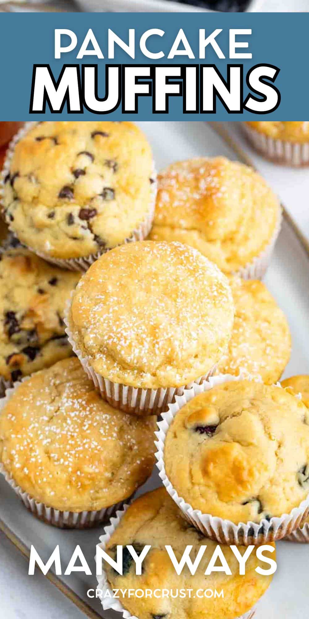 A platter of assorted Pancake Muffins, some topped with chocolate chips and others dusted with powdered sugar, displayed in white paper liners. Text reads: Pancake Muffins Many Ways crazyforcrust.com.