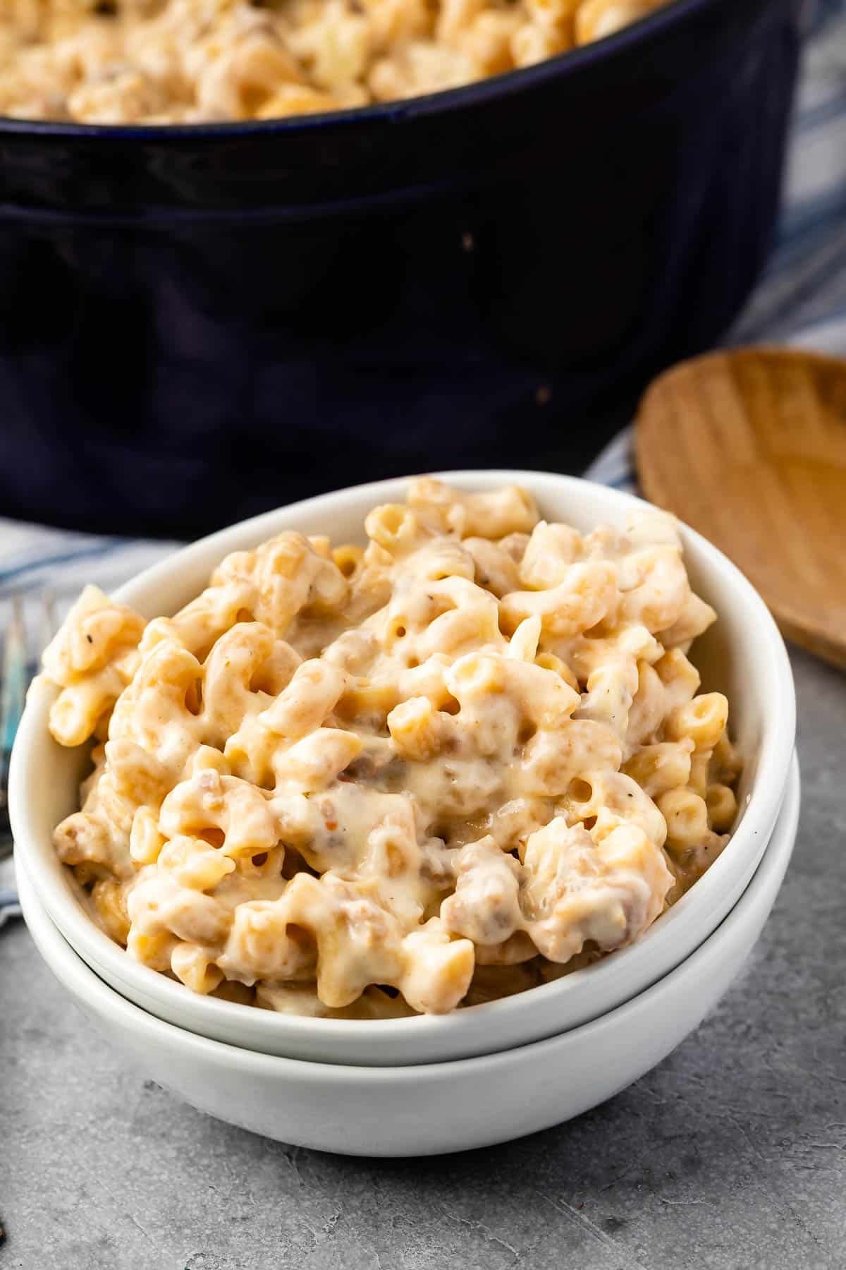 Mac and cheese in a white glass bowl.