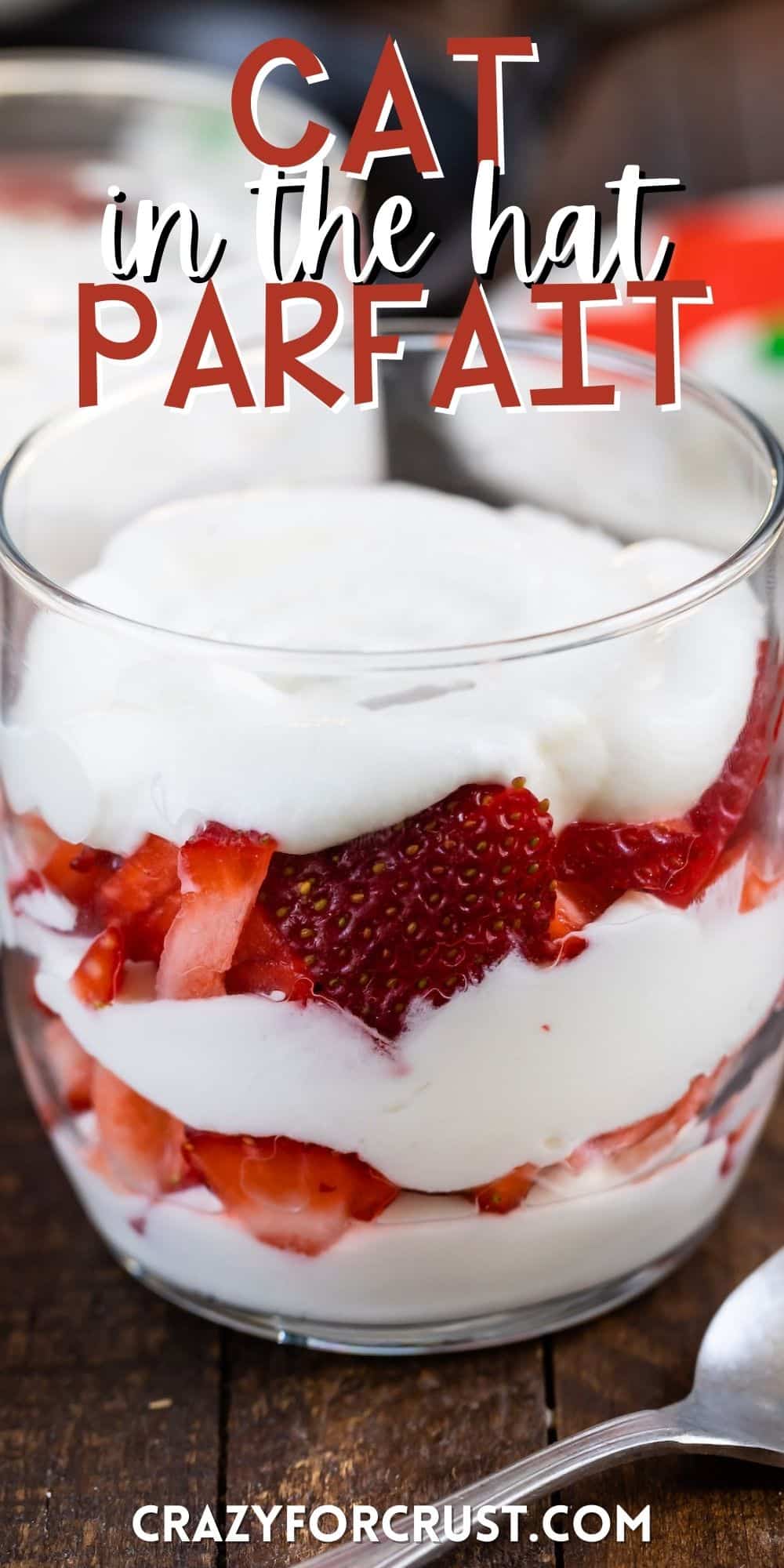 cream and strawberries parfait in a clear class with words on the image.