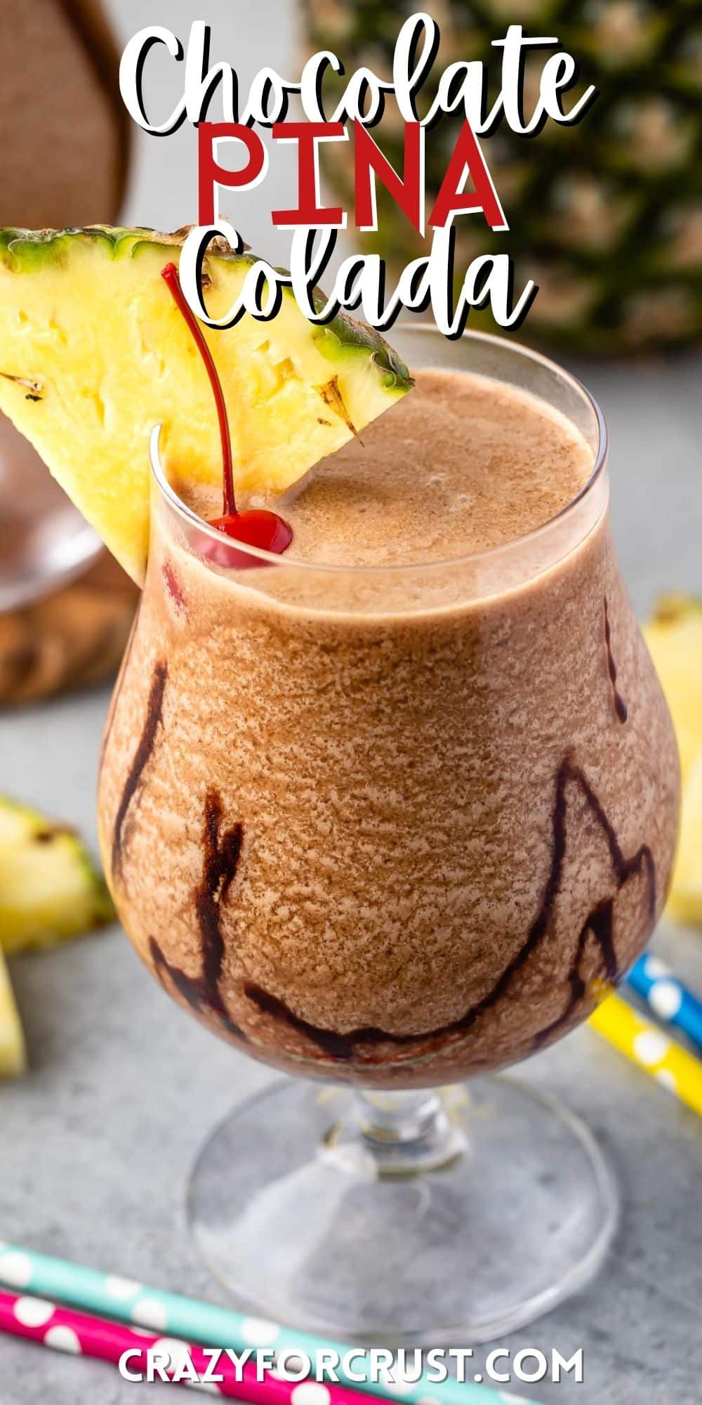 chocolate pina colada in a clear glass with a pineapple and cherry on the rim with words on the image.