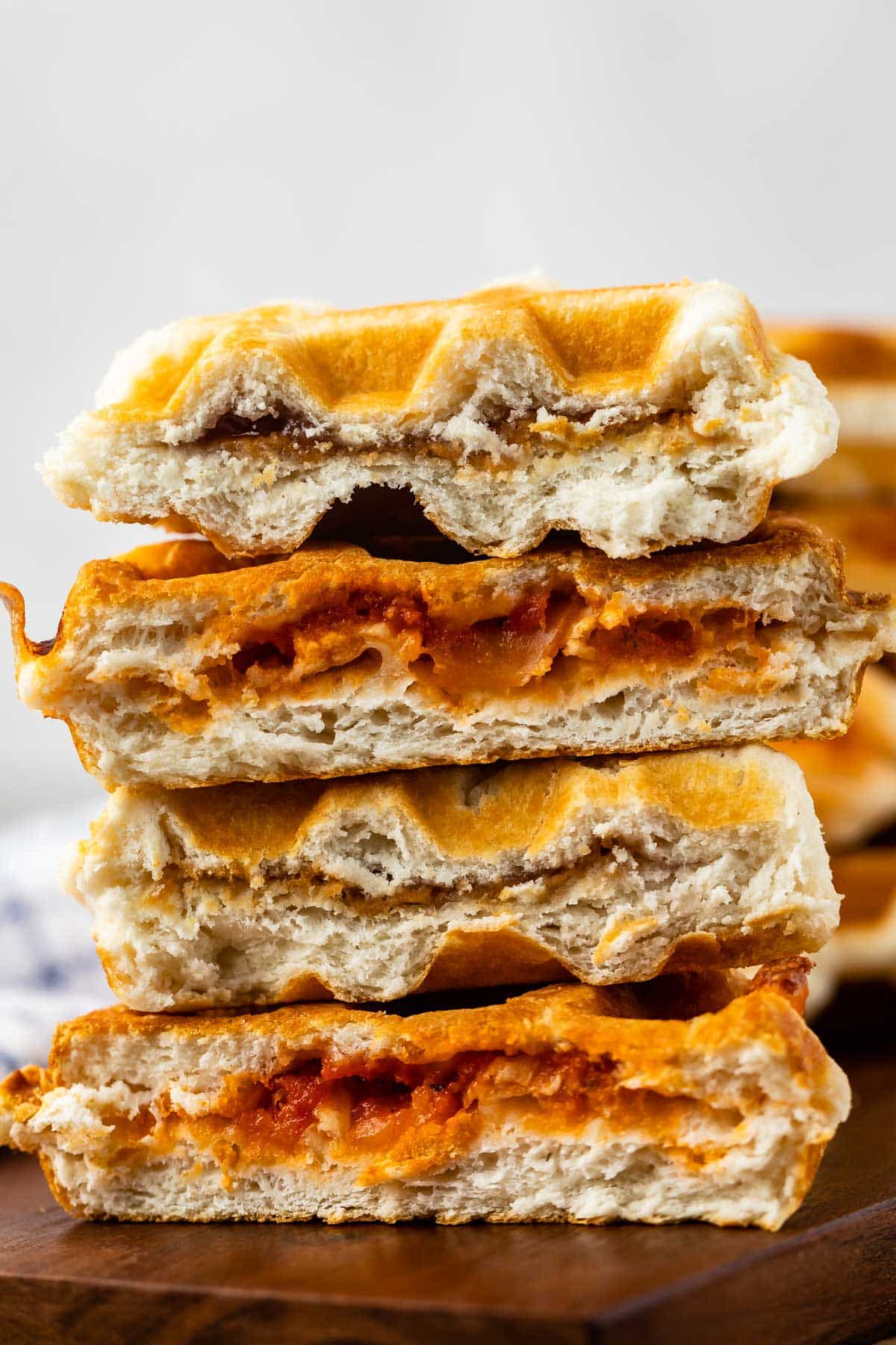 stacked waffles stuffed with peanut butter and jelly and pizza ingredients.