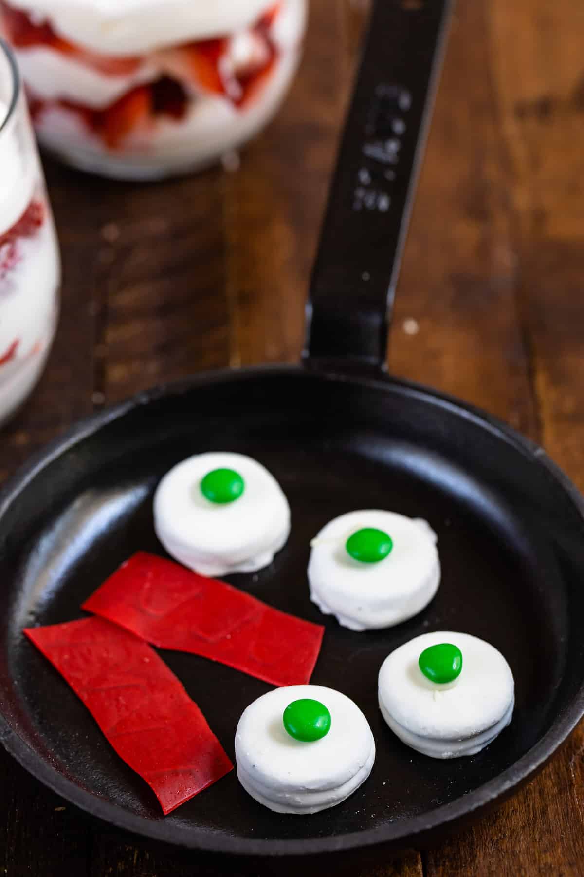 green eggs and ham made from various candies in a small metal pan.