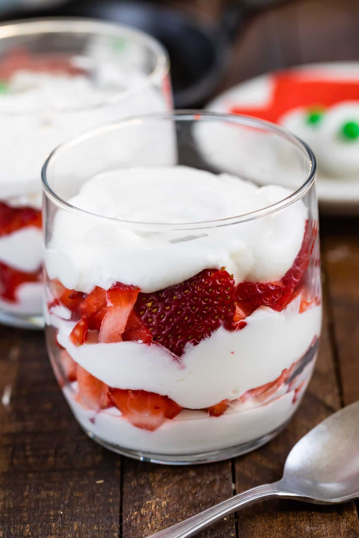 cream and strawberries parfait in a clear class.