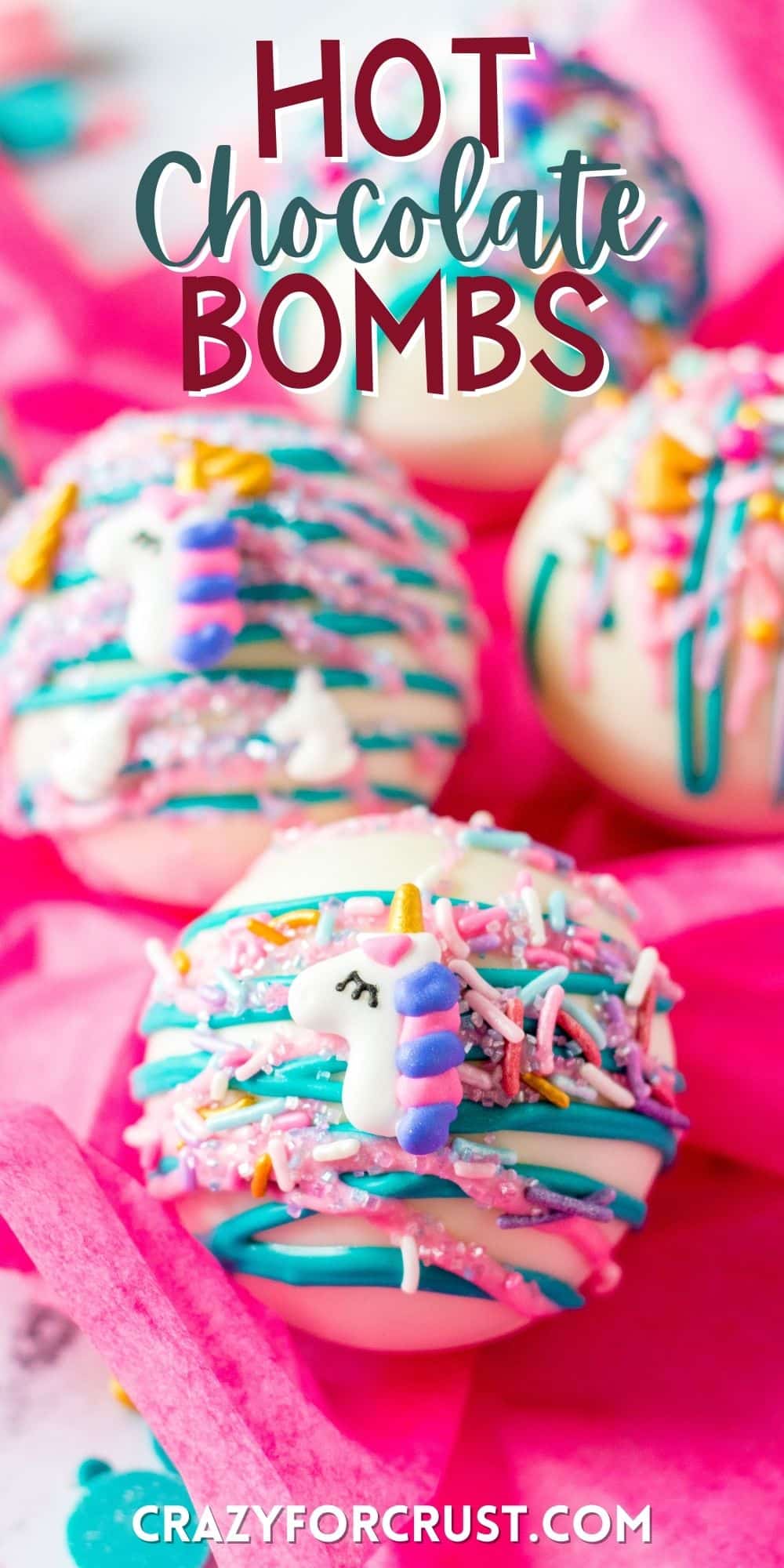 white chocolate ball covered in pink and blue frosting and sprinkles with words on top.