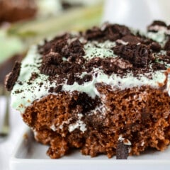 chocolate cake with mint frosting and oreo pieces on top.