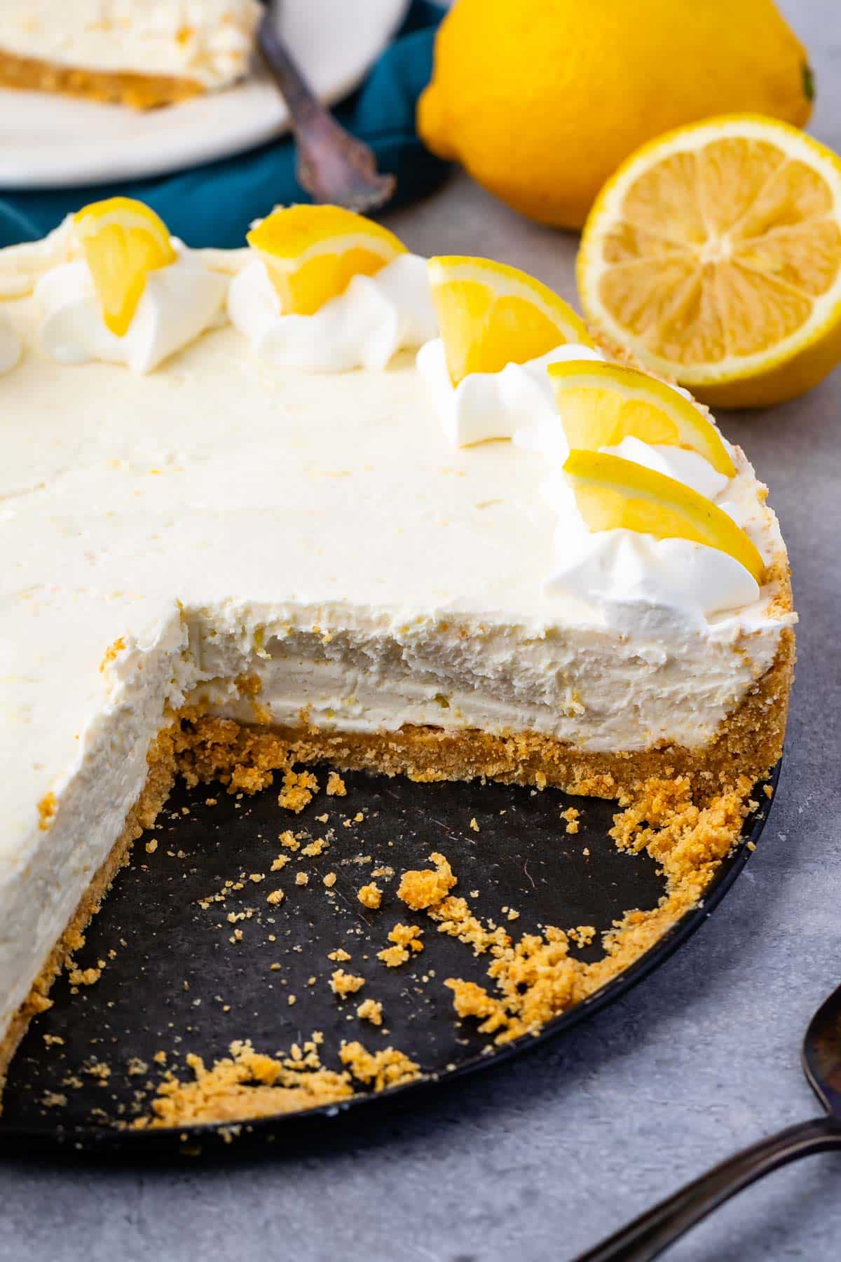 white cheesecake with lemon slices on top.