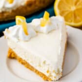 triangle slice of cheesecake with lemon slices on top.
