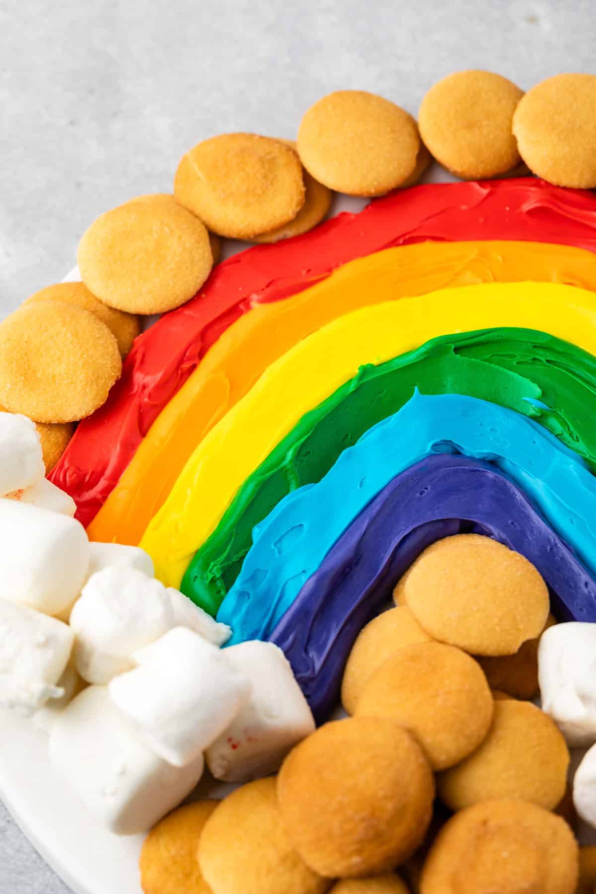 close up of rainbow buttercream board with nilla wafers and marshmallows