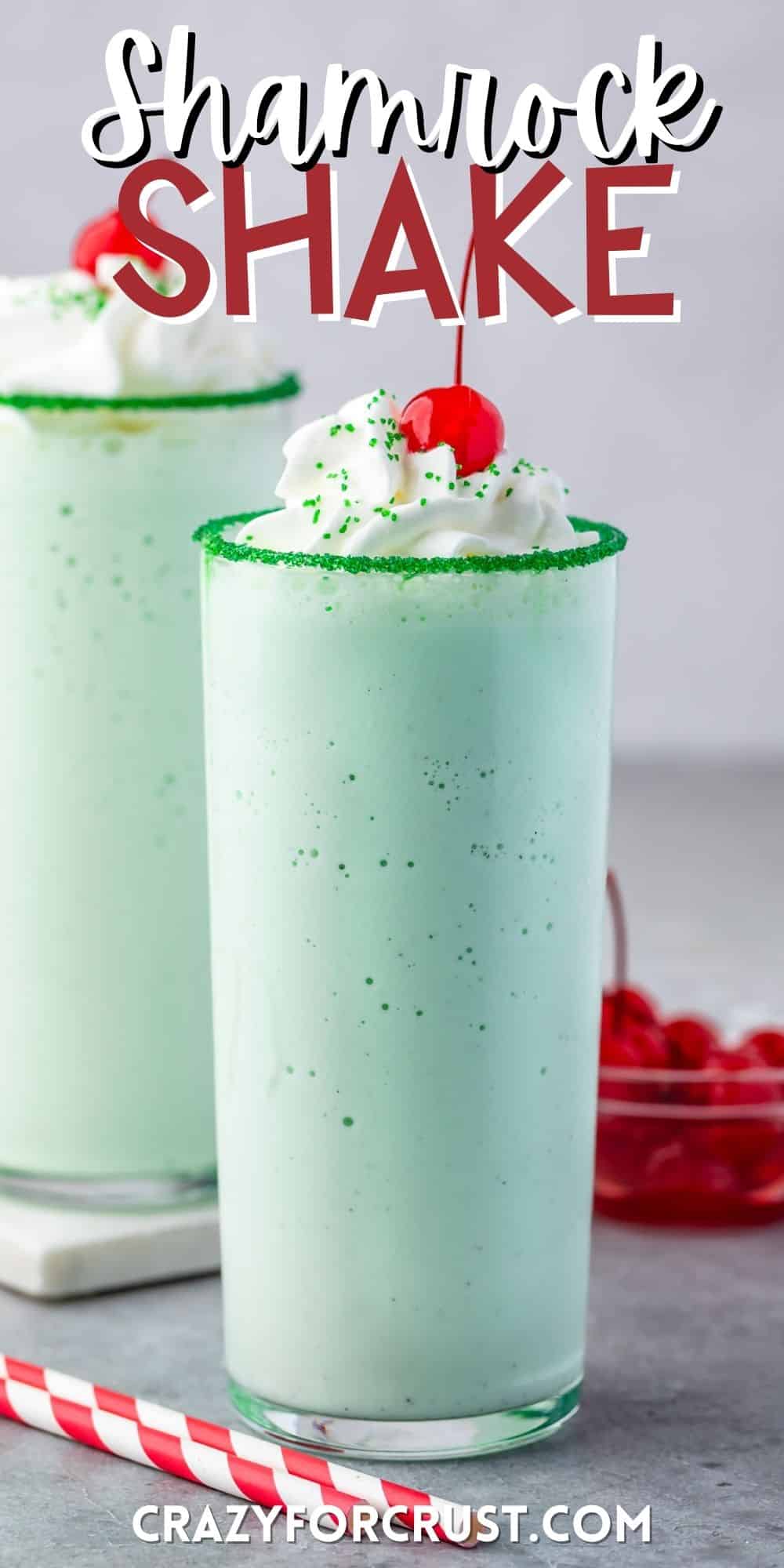 green shake in a clear glass topped with whipped cream and a cherry with words on the image.