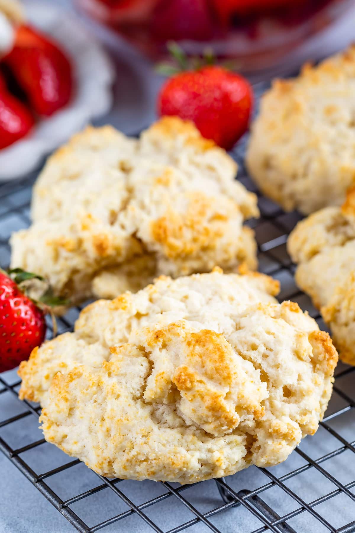 biscuits on a drying rack around strawberries.